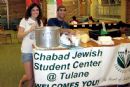 Board members Edo Samra and Alex Naparstek serve matza ball soup to freshmen during move-in week.