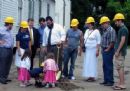Mendel, Chaya and Shifra Rivkin lay the cornerstone.